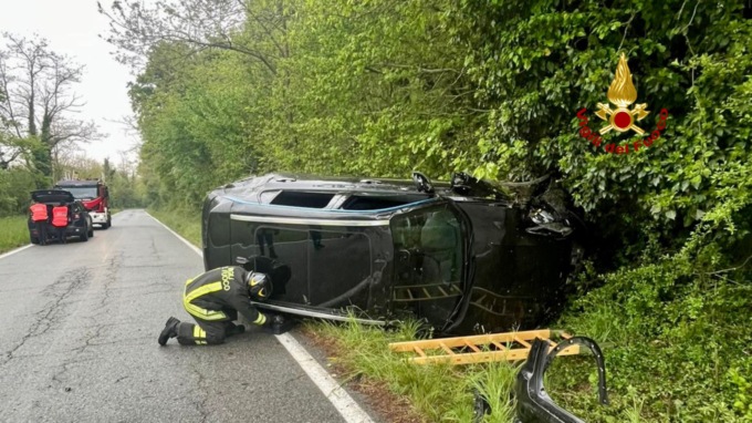 Auto esce di strada e termina la sua corsa su di un fianco